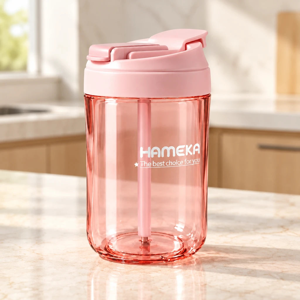 Pink tumbler with a lid on a light background, featuring the brand 'Hameka'.