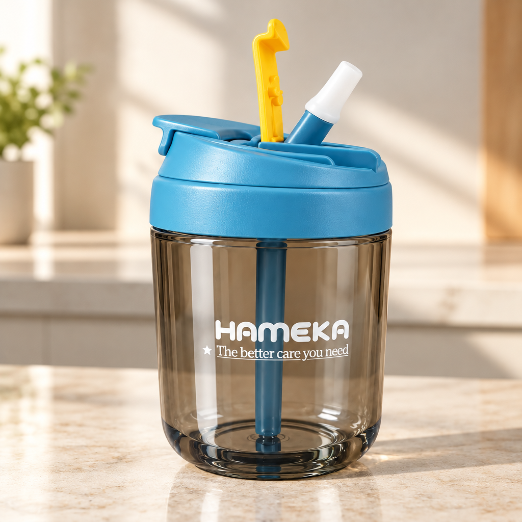A HAMEKA clear plastic water bottle with a translucent blue lid and matching blue straw, featuring a yellow and white straw accessory and white printed branding on the front, set against a solid beige background.